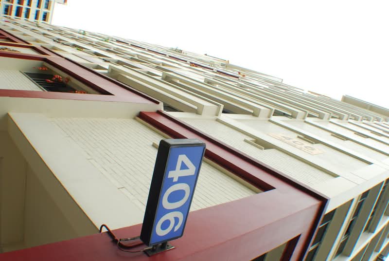 Looking up at HDB Block 406 with its blue block sign
